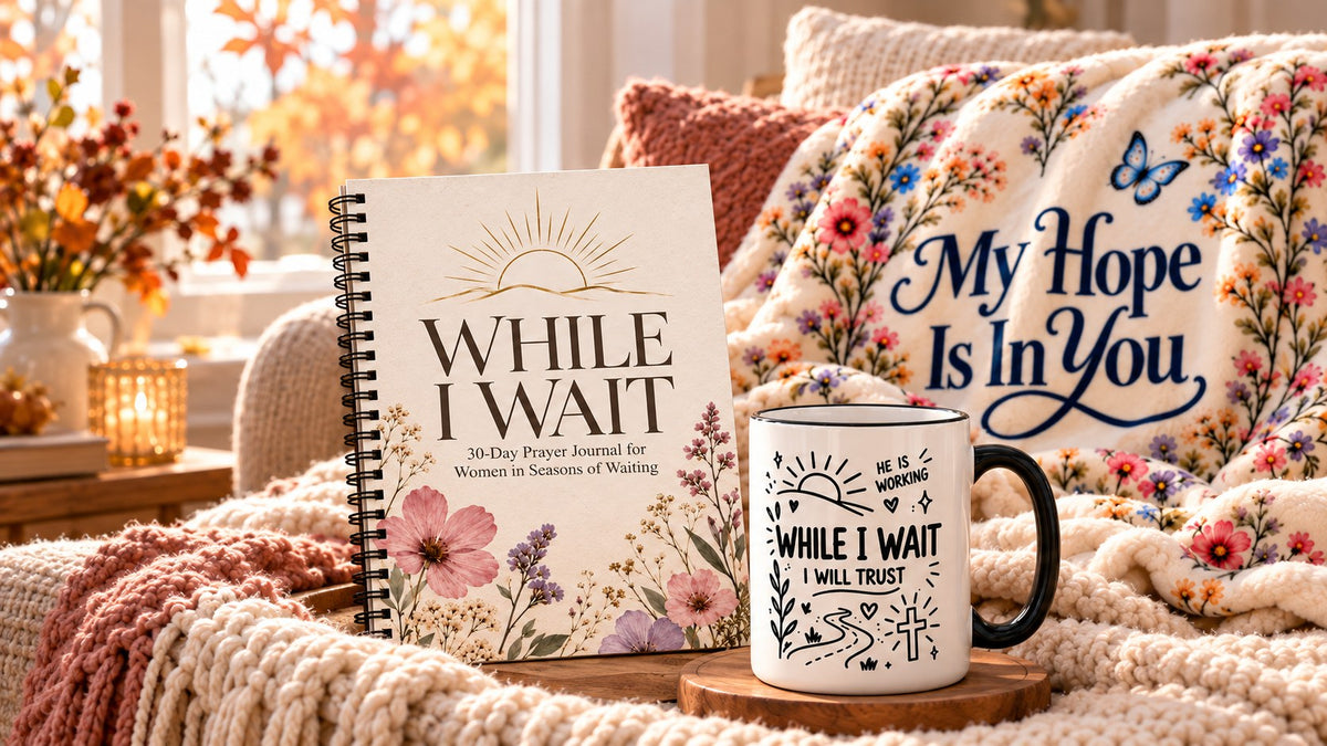 Christian gifts for a friend in a season of waiting: While I Wait prayer journal, My Hope Is In You floral throw blanket and While I Wait, I Will Trust Scripture mug on a cozy chair