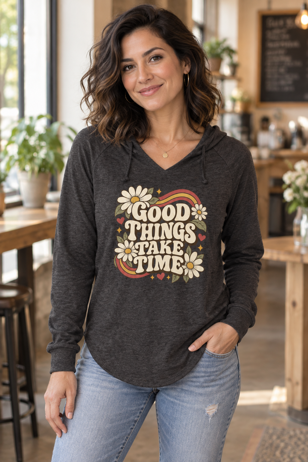 Woman wearing the Shadow Good Things Take Time wave wash hoodie in a cafe