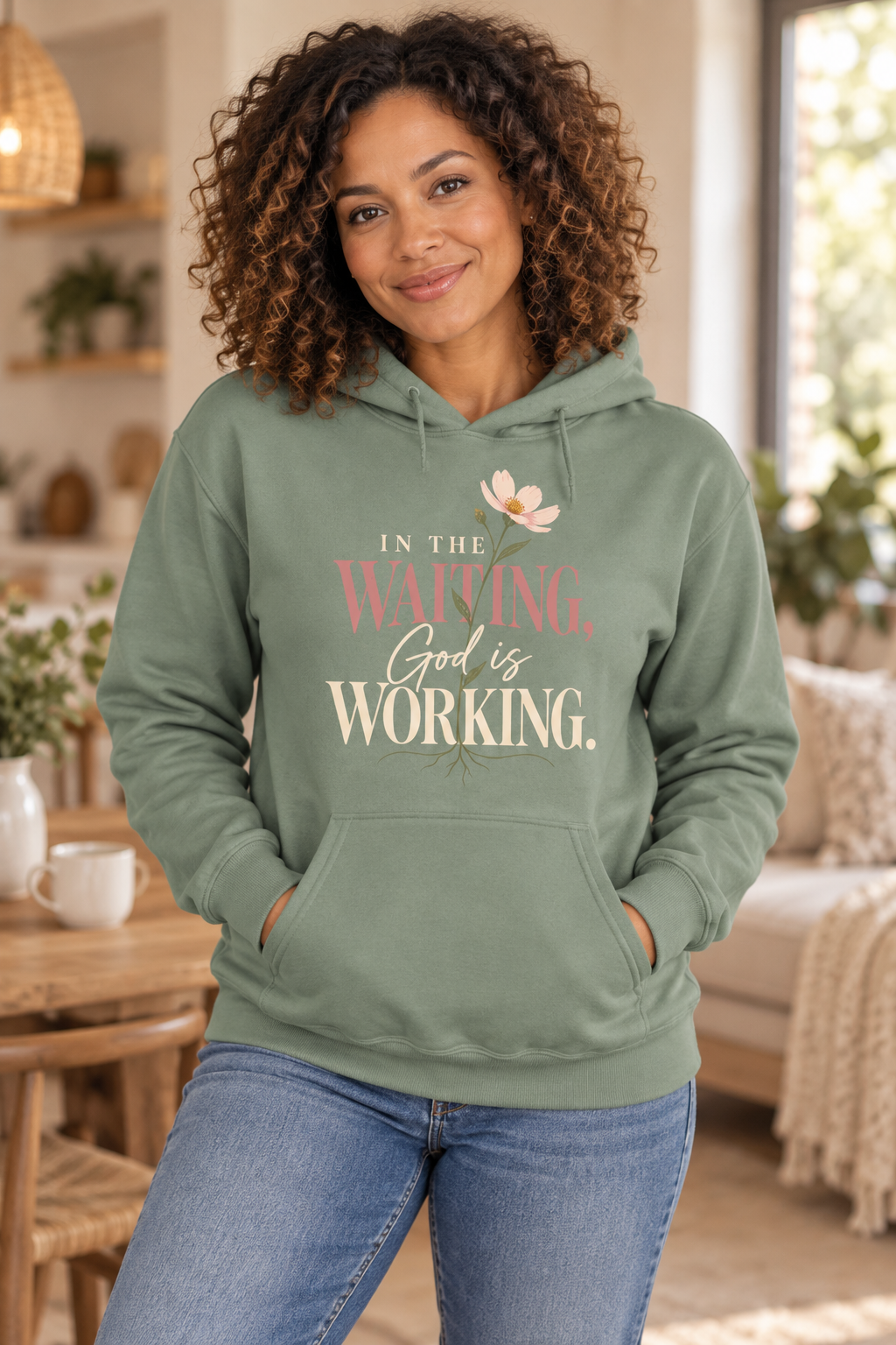 Woman wearing the Sage In the Waiting, God Is Working hoodie