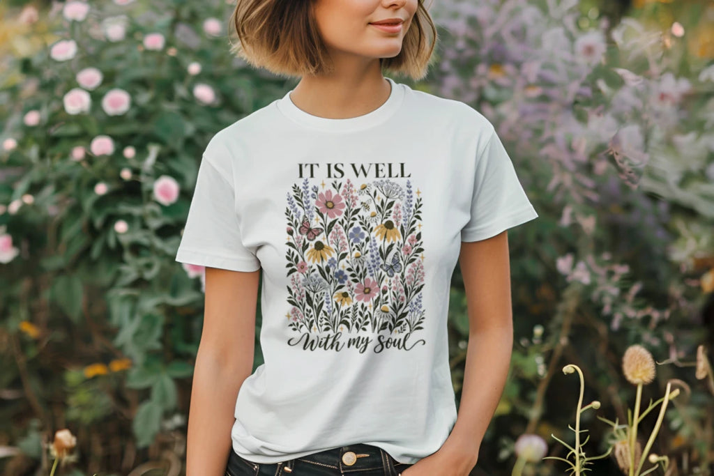 Close-up of the It Is Well With My Soul wildflower design on a light tee