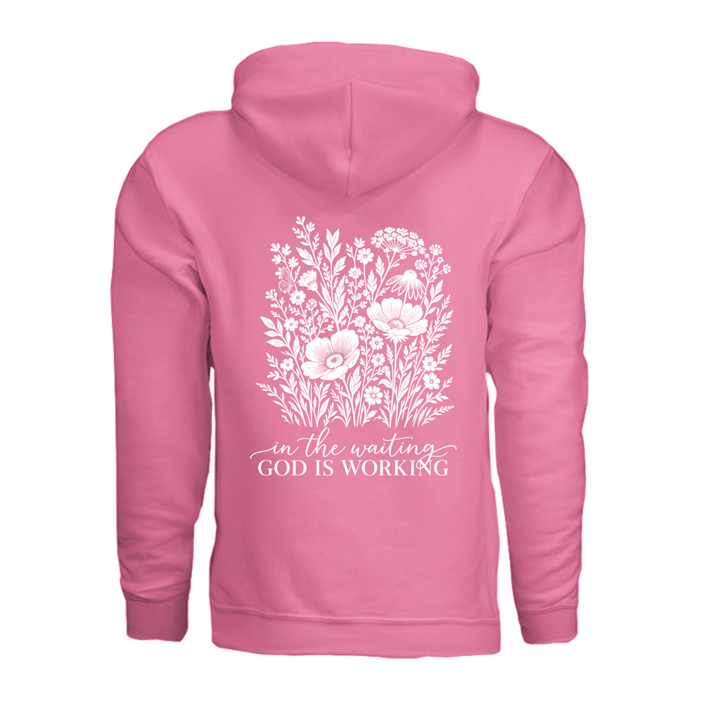 In the Waiting, God Is Working floral hoodie in Pink Lemonade, back view with the full wildflower and message design