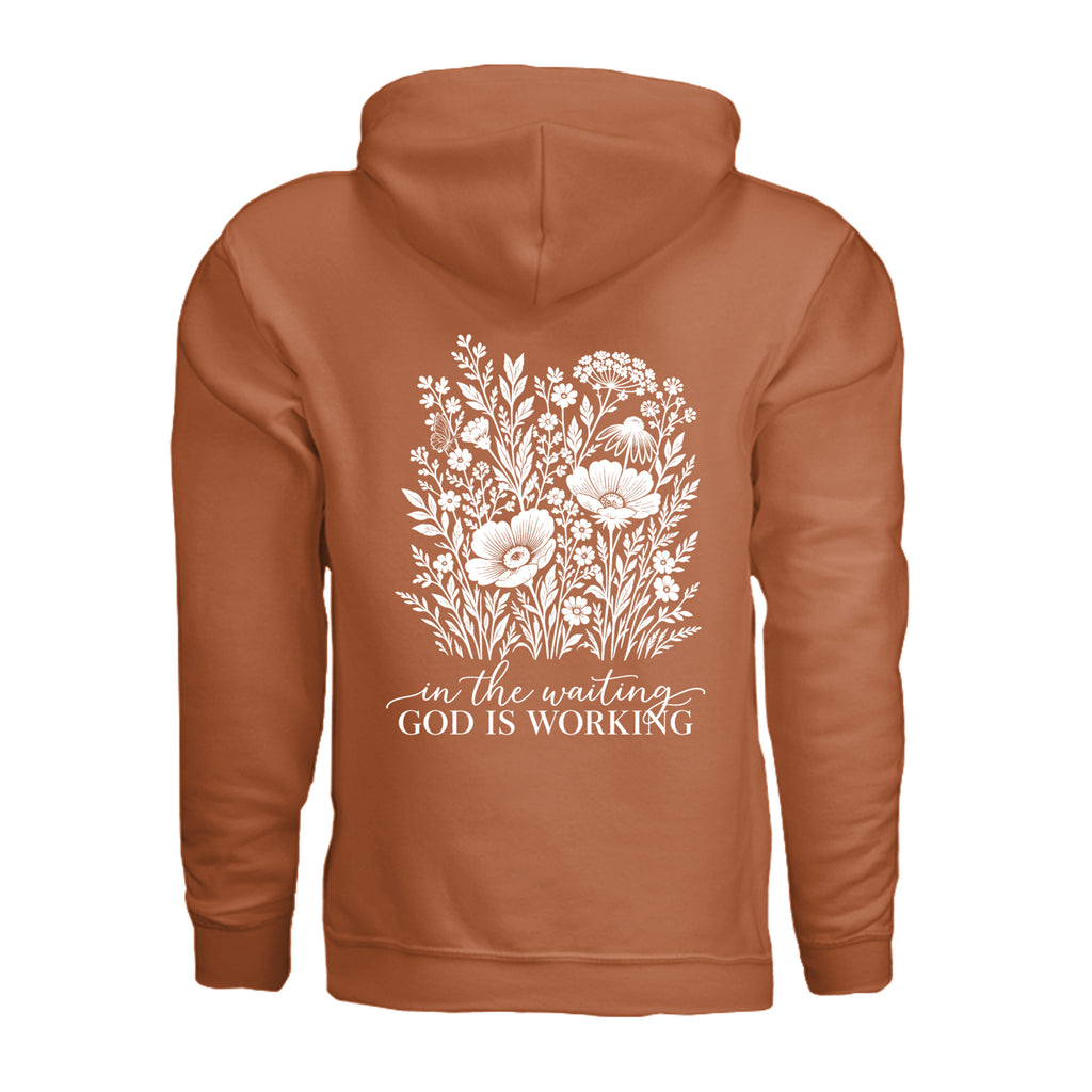 In the Waiting, God Is Working floral hoodie in Texas Orange, back view with the full wildflower and message design