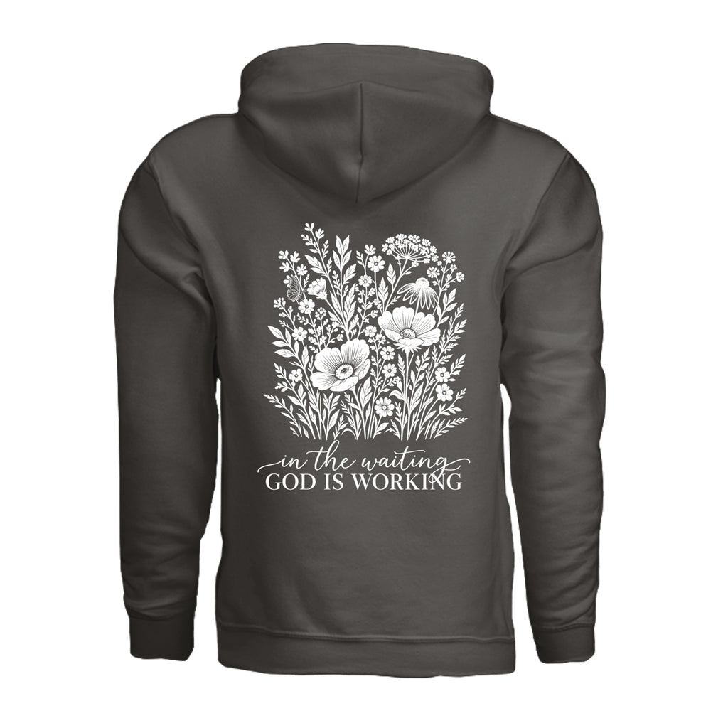 In the Waiting, God Is Working floral hoodie in Smoke, back view with the full wildflower and message design