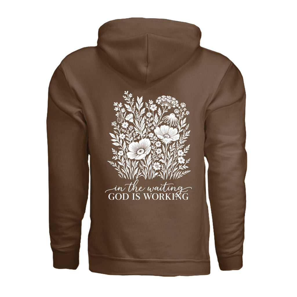 In the Waiting, God Is Working floral hoodie in Cocoa, back view with the full wildflower and message design