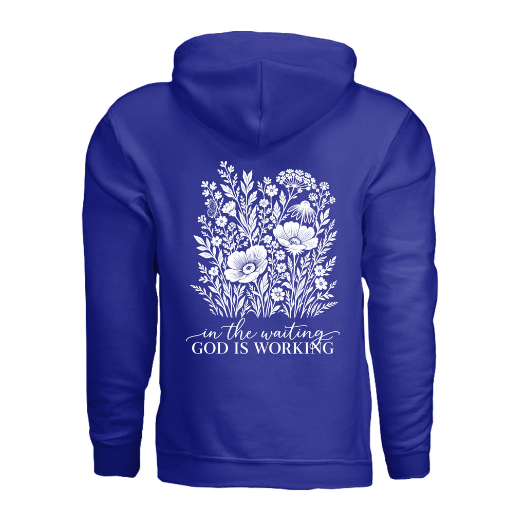 In the Waiting, God Is Working floral hoodie in Cobalt, back view with the full wildflower and message design