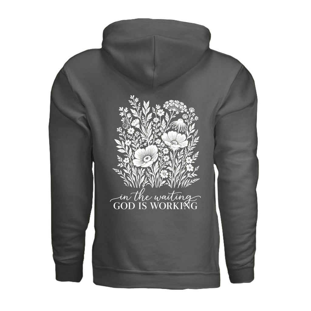In the Waiting, God Is Working floral hoodie in Charcoal, back view with the full wildflower and message design